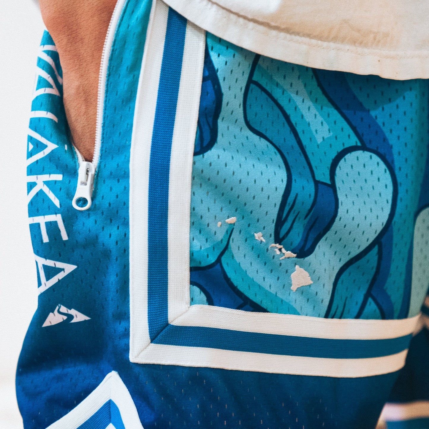 Blue patterned athletic shorts with zipper pocket