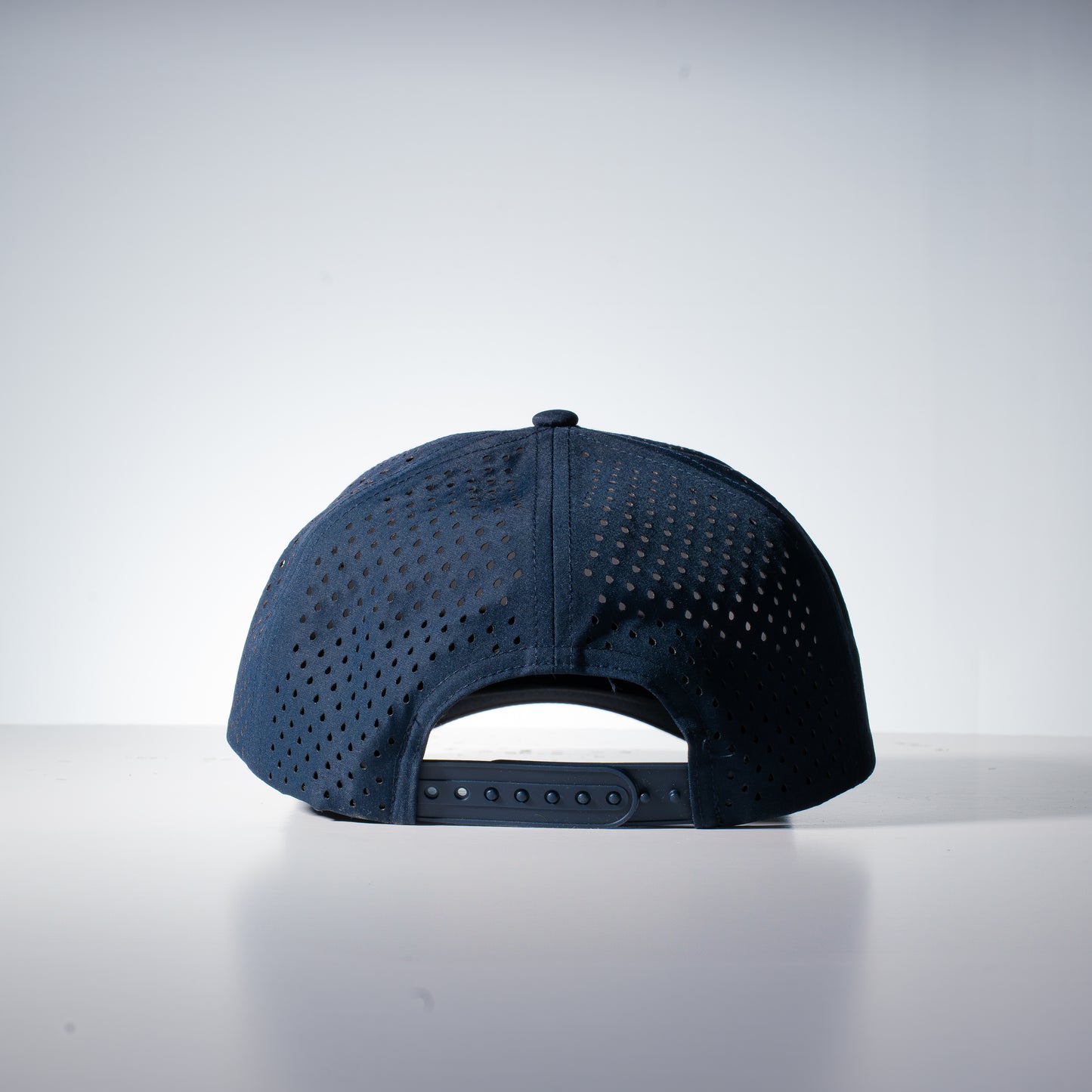 back of a navy hat with mini holes on the fabric