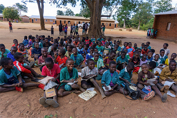children sitting outdoors school classroom Africa