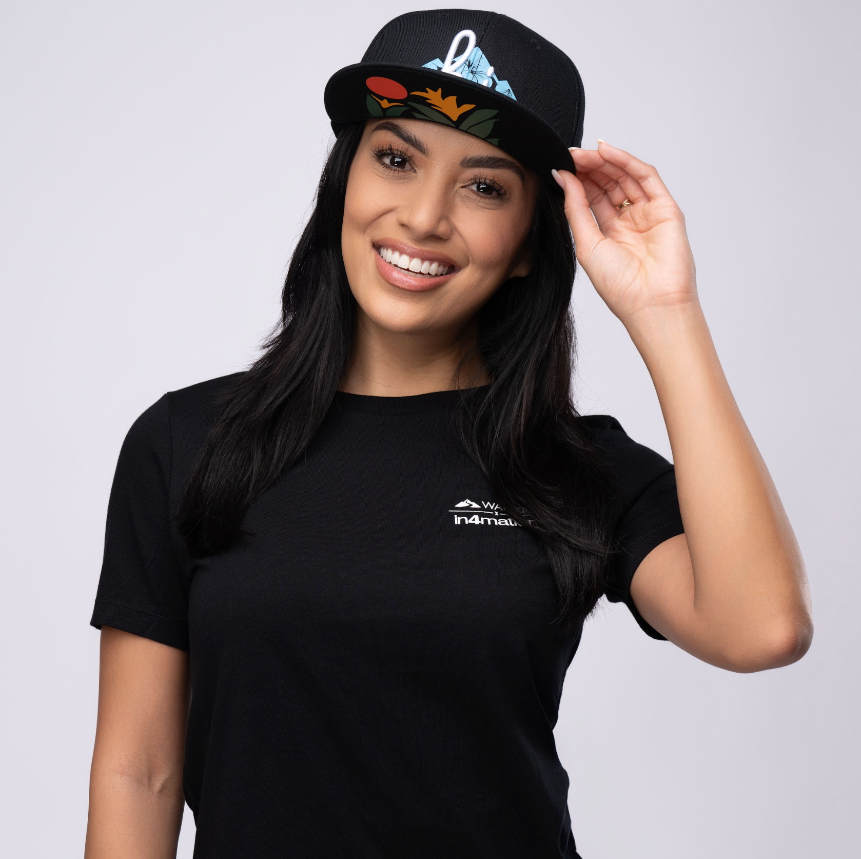 Young woman wearing black t-shirt and cap smiling