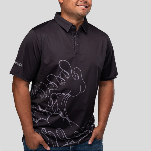 man wearing a black polo with an aaron kai wave on the front