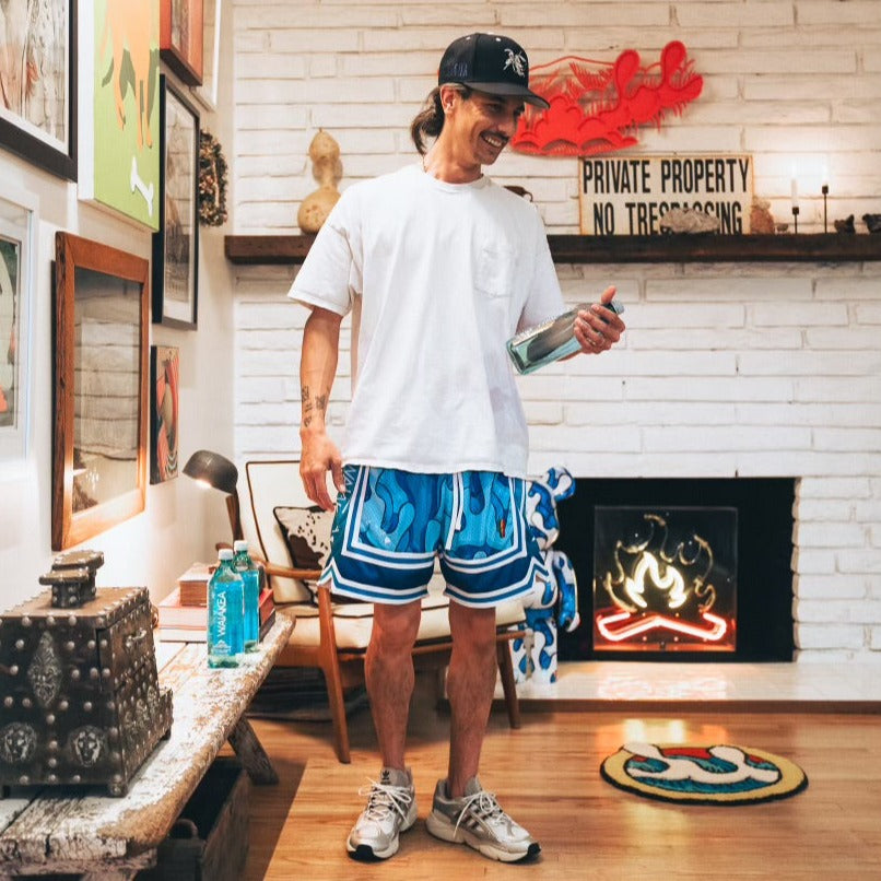 Man in casual outfit standing in decorated room.