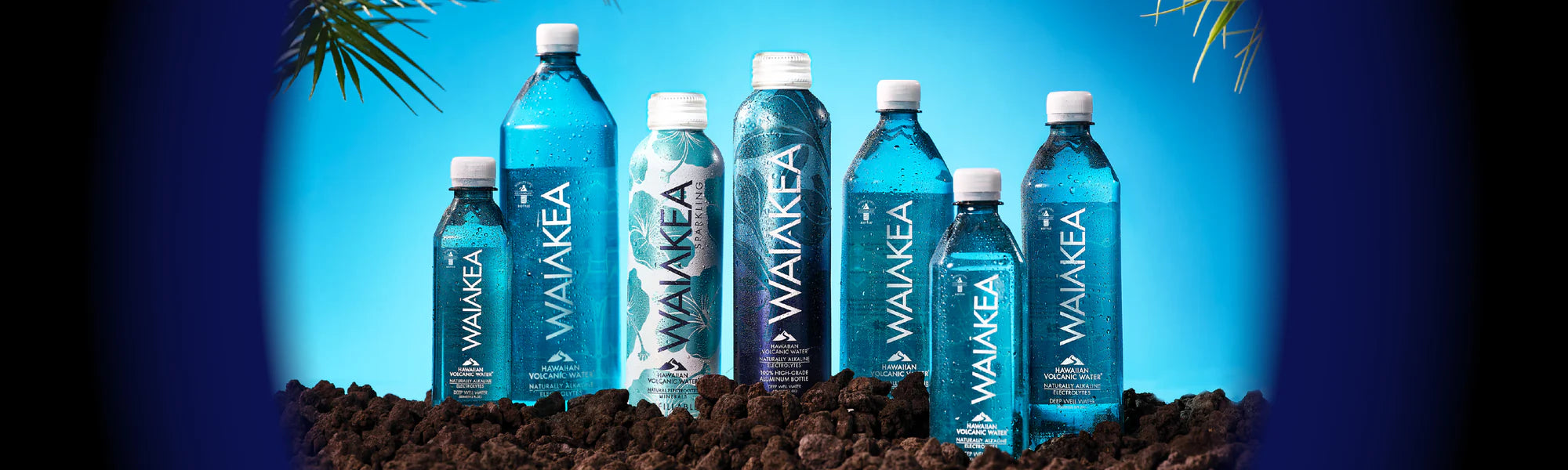 Waiakea Hawaiian volcanic water bottles on lava rocks background