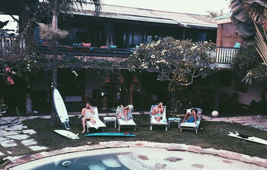 Zach, Ben, and friends working and lounging out by the pool