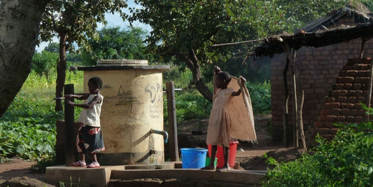 Children using a community tap