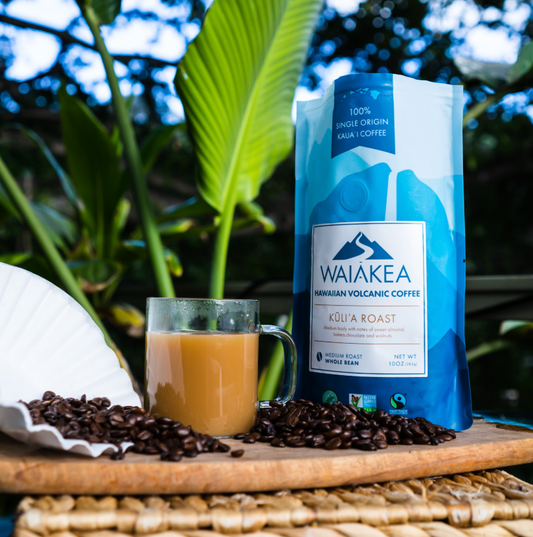 waiakea coffee bag with a cup of coffee next to it