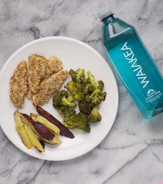 Healthy Paleo Baked Chicken Fingers next to a Waiakea bottle