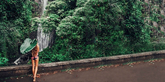 Woman watching a Hawaiian waterfall