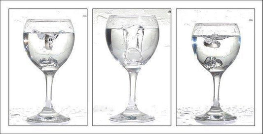 Stages of antacid tablet being dissolved in a wine glass