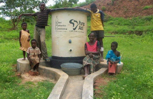 Children surrounding a Pump Aid pump