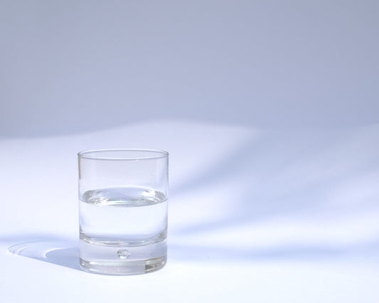 Glass of water in front of a white background