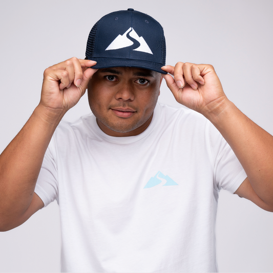 Man wearing baseball hat with white shirt
