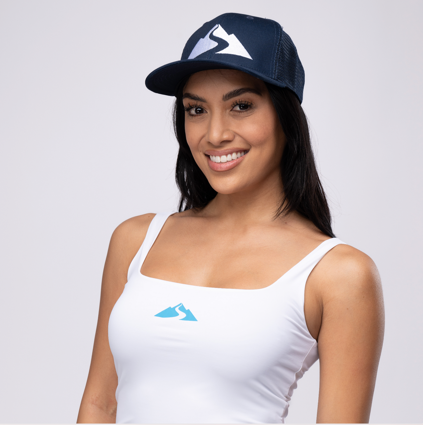 woman wearing baseball hat with Waiākea logo on front 