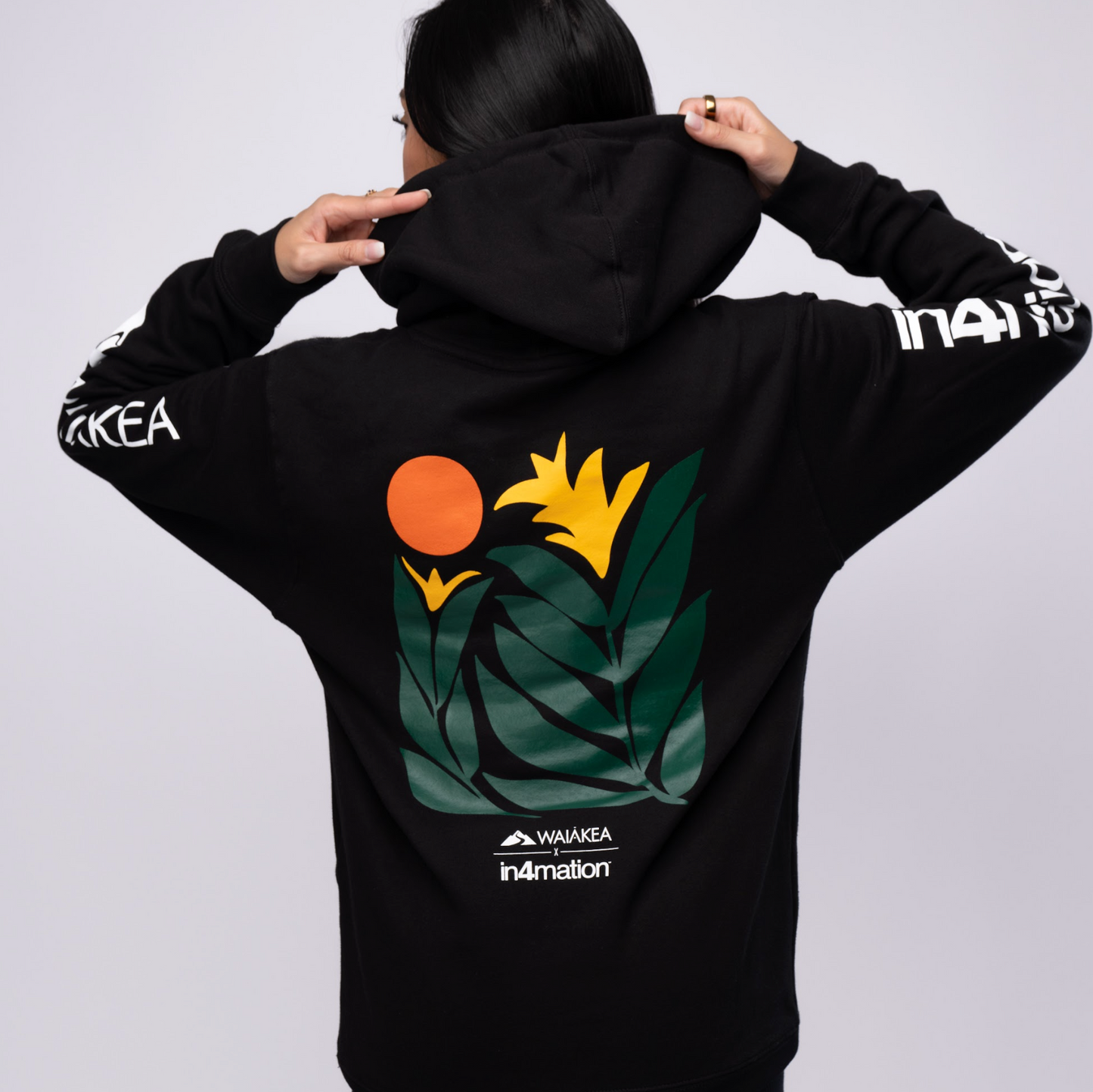 Black hoodie with floral design and brand logos.