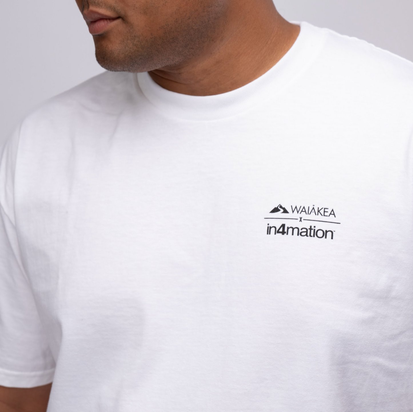 Waiakea x In4mation on the front of a white shirt
