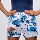 Colorful graphic shorts with blue camouflage pattern and retro surfer design